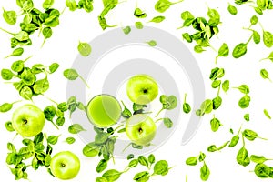 Green vegetables background with vegetable smoothies. Fresh apples, arugula salad on white background top view