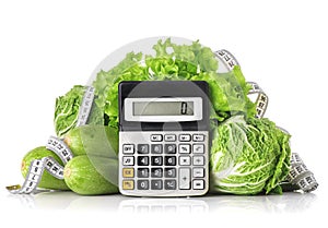 Green vegetables, calculator and centimeter isolated on a white