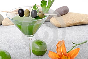 Green vegetables cocktail in a environment of sand and pebble st
