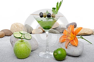 Green vegetables cocktail in a environment of sand and pebble st