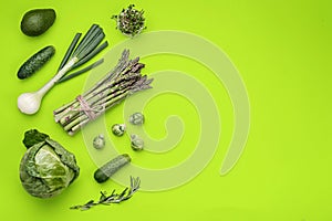 Green vegetables flat lay concept on green background