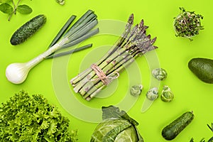 Green vegetables flat lay concept on green background