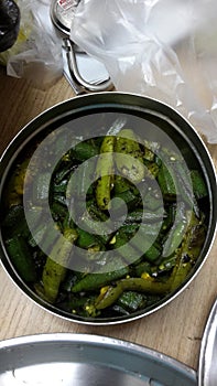 Green vegetables fried in a steel bowl or container