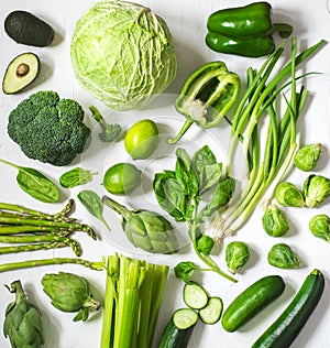 Green vegetables and fruits on a white background. Fresh organic healthy food.