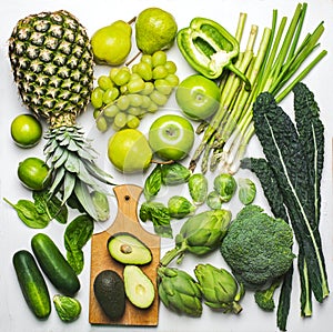 Green vegetables and fruits on a white background. Fresh organic produce photo