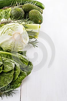 Green vegetables over white wooden background