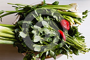 Green vegetables and red Chilli peppers  on the table.