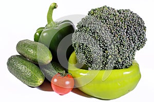 Green vegetables with a red tomato