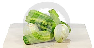 Green vegetables on wooden boards and white background.