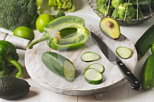 Green vegetables on a wooden cooking board.