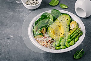 Green vegetarian buddha bowl lunch with grilled vegetables and quinoa, spinach, avocado, brussels sprouts, zucchini, asparagus, ed