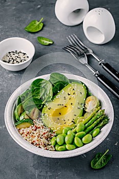 Green vegetarian buddha bowl salad with grilled vegetables and quinoa, spinach, avocado, brussels sprouts, zucchini, asparagus, ed