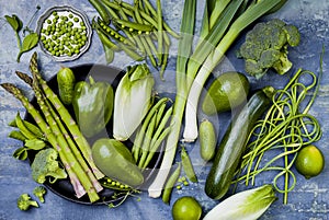 Green veggies group. Vegetarian dinner ingredients. Green vegetables variety. Overhead, flat lay, top view.