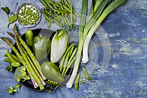 Green veggies group. Vegetarian dinner ingredients. Green vegetables variety. Overhead, flat lay, top view, copy space.