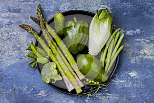 Green veggies group. Vegetarian dinner ingredients. Green vegetables variety. Overhead, flat lay, top view, copy space.