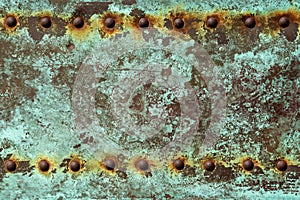 Green verdigris background with rivets