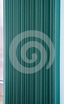 Green vertical textile window blinds.