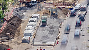 Green vibration roller compactor rolls on a stones at road construction and repairing timelapse