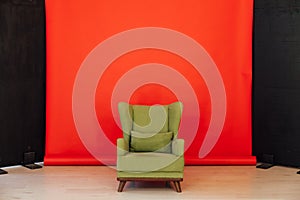 Green vintage chair in the interior of the red black room