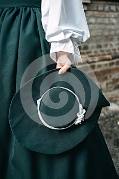 Green vintage hat 1800s early 1900s clothing in female hand.