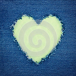 Green vintage heart on blue denim fabric