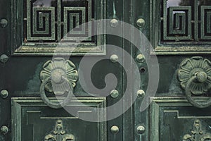 Green vintage old metal doors with door knocker. Antique doors