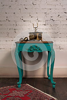 Green vintage wooden table and old golden telephone set