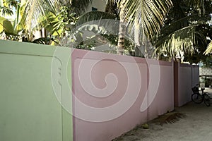 Green and violet wall in a maldivian village