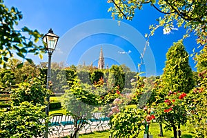 Green Volksgarten park of Vienna and city hall view