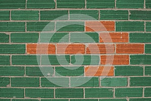 Green Wall with Red Bricks shaping an arrow pointing at left