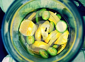 Green wallnuts and limes in homemade liquer.