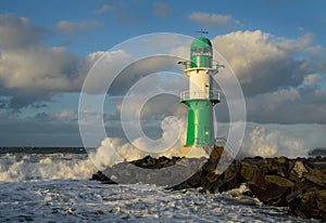 Green WarnemÃÂ¼nde Lighthouse with waves photo