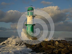 Green WarnemÃÂ¼nde Lighthouse with surf photo