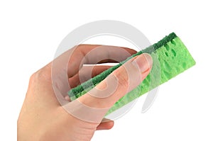 Green washing sponge for dishes in a hand isolated, side view closeup