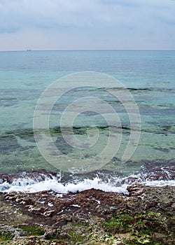 Green water rocks and seafoam