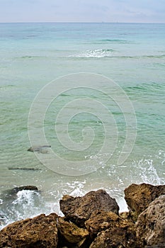 Green water rocks and seafoam