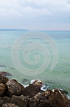 Green water rocks and seafoam