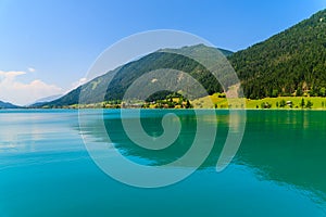 Green water Weissensee lake in Alps Mountains, Austria