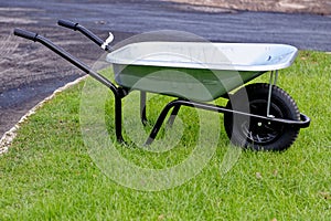 Green wheelbarrow in a garden