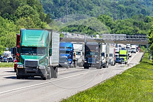 Green 18-Wheeler Leads Heavy Highway Traffic