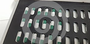 Green and white capsulas compounding photo
