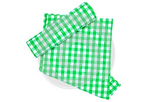 A green white checkered napkin or picnic tablecloth texture with a rolled towel isolated on white. Kitchen towels. Backdrop for