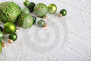 Green and white christmas background with snow and balls for dec