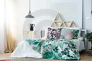 Green and white floral bedclothes photo