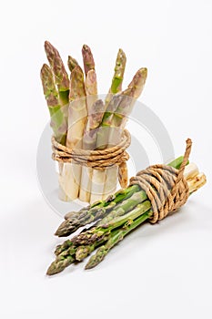 Green and white fresh asparagus on a gray background