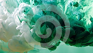 Green and white ink diffusing in water, forming swirling clouds.