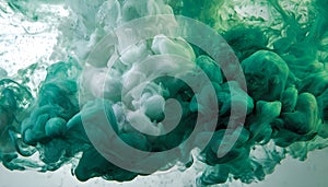 Green and white ink diffusing in water, forming swirling clouds.
