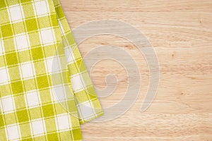 Green and white kitchen textile texture on wood background