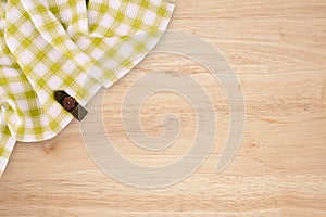 Green and white kitchen textile texture on wood background