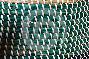 Green and white plastic weave texture pattern. texture of rattan mats, baskets or furniture. Abstract weave pattern background